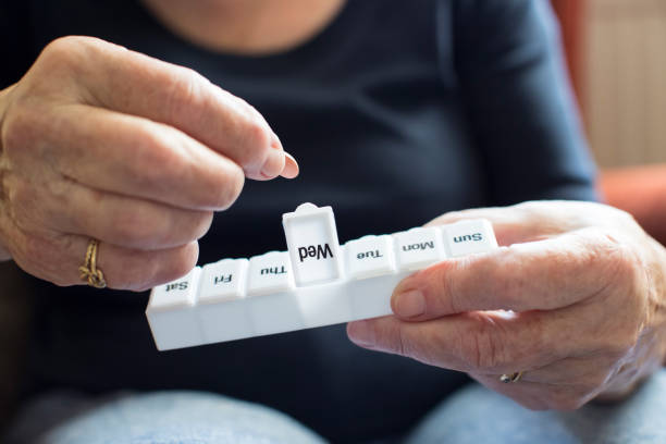 Seniors Woman Taking Medication From Pill Box