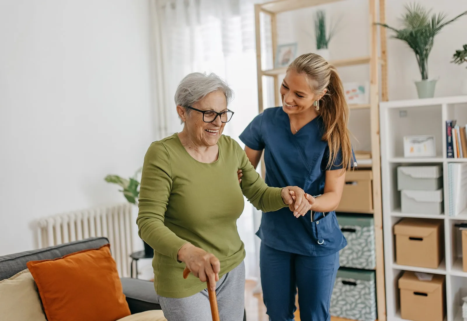 Home Safety Tips for Seniors - caregiver walking with elderly woman in her home