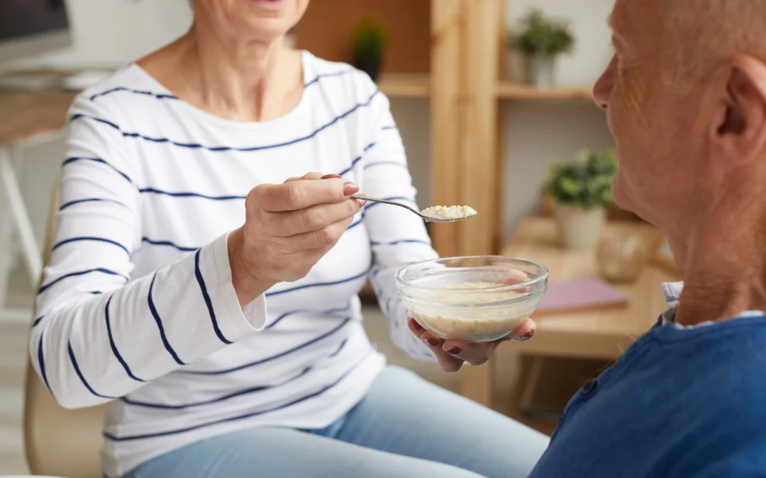 soft food ideas for the elderly - elderly woman feeding soft food to an elderly man