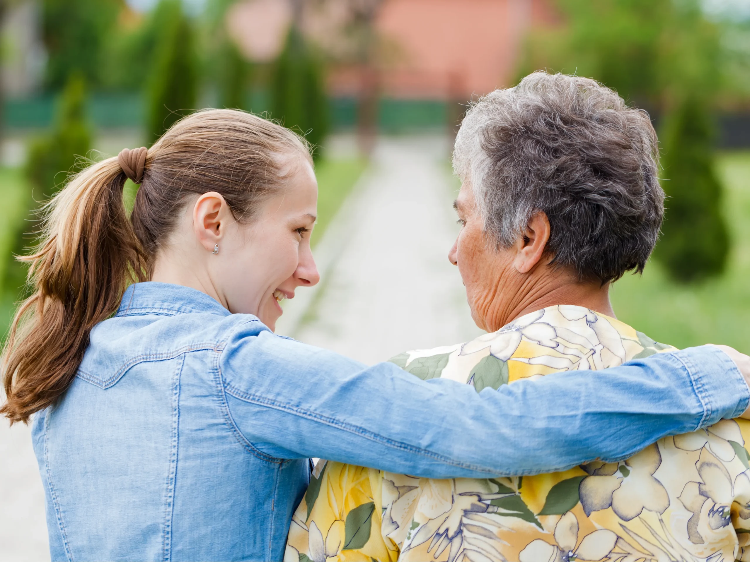 woman with arm around elderly parent